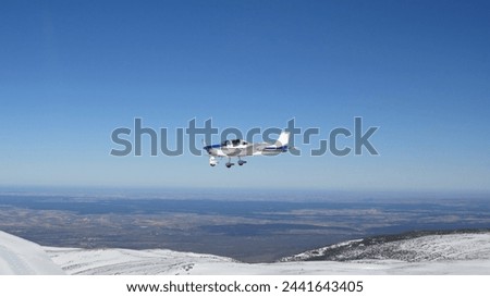 ultralight sport plane flying sierra guadarrama snow madrid extreme sport Royalty-Free Stock Photo #2441643405