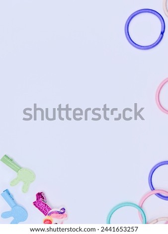 Hair Accessories Display: Colorful hair ties and clips artfully arranged on a pristine white background, perfect for captivating social media posts, product ads, or promotional materials.