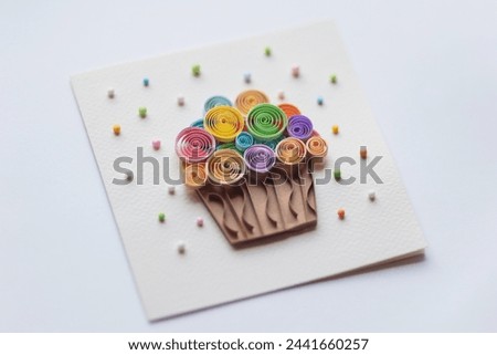 Paper cupcake quilling paper art on white background. Delicious Cupcakes for party, birthday. Top view. Hand made of paper quilling technique. handicraft at home, card craft, Business concept. Royalty-Free Stock Photo #2441660257