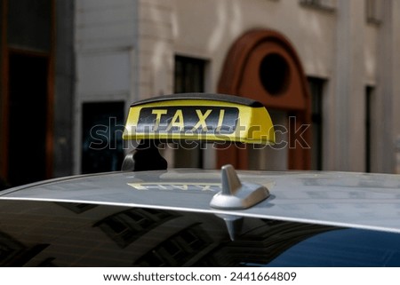 Checker taxi lighted rooftop car on a blurred background