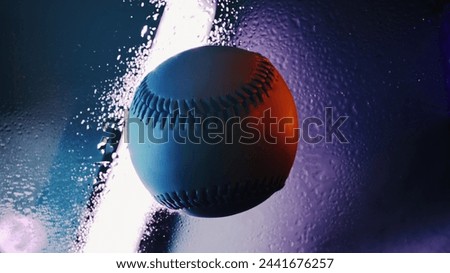 Baseball art background with wet water droplets by artistic lighting over ball for sport closeup.