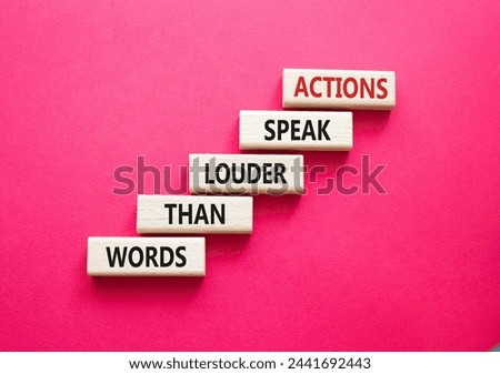 Actions speak louder than Words symbol. Wooden blocks with words Actions speak louder than Words. Beautiful red background. Business and Actions concept. Copy space.