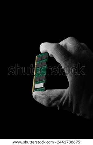 In the Darkness: Hand Securely Grasping RAM DDR4 Sodimm for PC. High quality photo