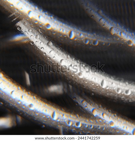 raindrops on a metal pipe, wet pipes, background, pipes at a construction site, fittings in the rain, construction site, gray hose, contrast photo, abstract, wet pipe