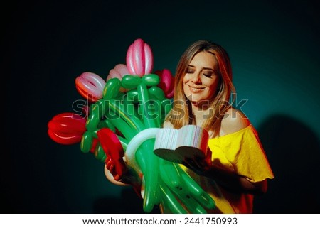 
Happy Woman Holding a Floral Balloon Bouquet and a Heart-Shaped Gift. Grateful girlfriend receiving a beautiful and creative present 
