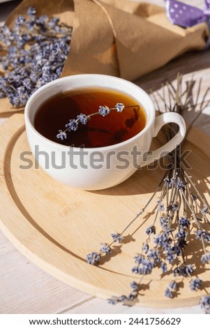 Healthy homemade cup of lavender tea. Organic natural home grown herb for teas. White cup of tea with dried lavender flowers. Healthy living wellbeing