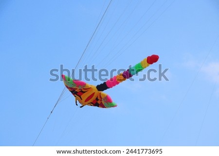 Colorful kites flying in the clear blue sky in summer in Mekong Delta Vienam. Happy moments childhood.