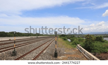Close-up view of multi-track railroad tracks stretching into the distance against a blue sky background