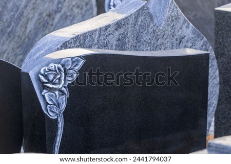 The stonemason has beautiful gravestones with decorations for sale Royalty-Free Stock Photo #2441794037
