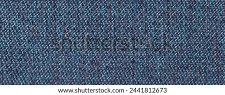 Navy blue background from woolen texture textile, closeup. Structure of the denim wicker fabric macro.