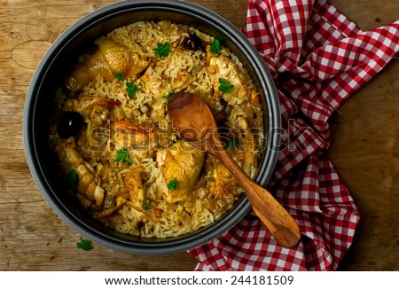 Stewed chicken with rice and dates in the crock-pot.selective focus Royalty-Free Stock Photo #244181509
