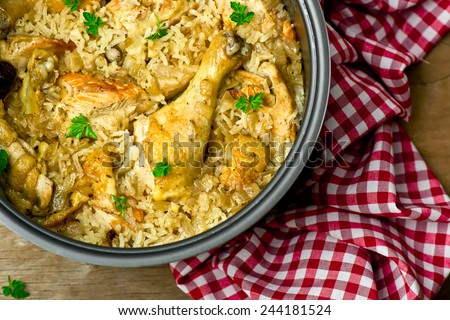 Stewed chicken with rice and dates in the crock-pot.selective focus Royalty-Free Stock Photo #244181524