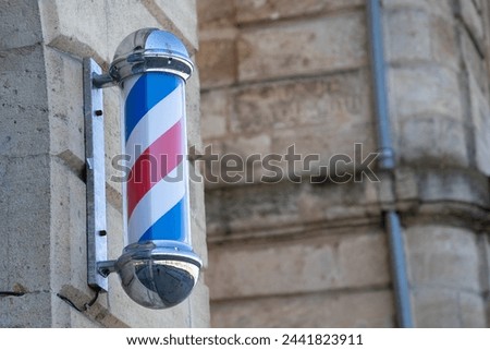 barber pole shop signboard cylindrical sign with light round facade hairdresser wall white red blue colors