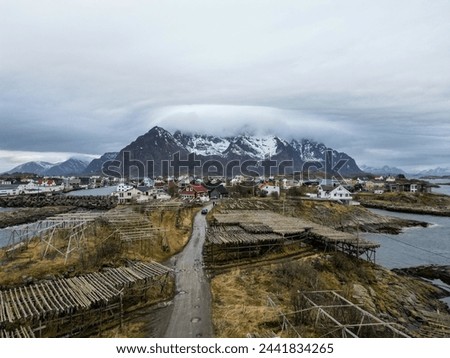 Aerial view of Fjord of mountain and sea. Top aerial view of island fisherman village with mountain and massive cloud. Panorama of henningsvaer soccer field in Lofoten island. Norway.