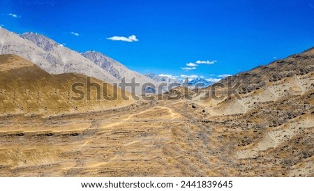 Landscape captured at Khardungla pass while traveling from Leh to Hunder town  Royalty-Free Stock Photo #2441839645