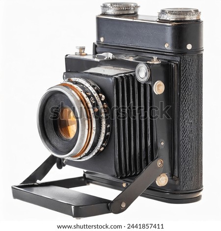 old antique bellows film camera, used for outdoors photography, close up front side view of camera isolated on white background