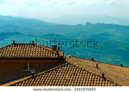 roofs of typical houses in a hilly panorama of central Italy. High quality photo Royalty-Free Stock Photo #2441876693