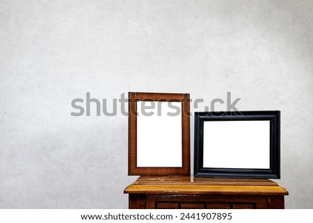 two Empty ornate picture frame on  wood table