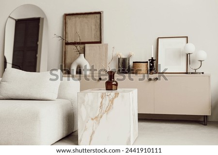 close up details flowers hyacinth in Interior design of aesthetic and minimalist living room with boucle armchair, wooden coffee table, pedant lamp, beautiful leafs in vase, decoration
