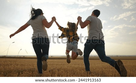happy family. father mother and daughter together run throw up in park sunset silhouette. people in park. happy family and little baby child summer. kid dream concept. children fun run