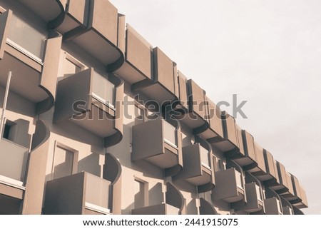 View from below of a series of off-season hotel balconies in the sun. geometrical, architectural photography, minimalist view, vintage feeling.