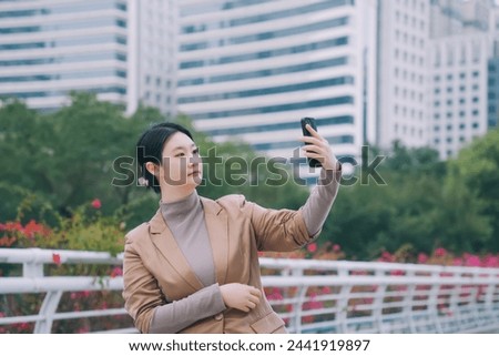 Professional Woman Capturing Self-Portrait Outdoors