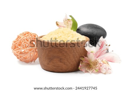 Orange sea salt in bowl, spa stones, rattan ball and floral decor isolated on white