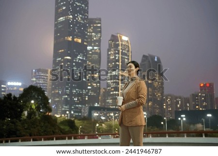 Confident Businesswoman Overlooking City at Dusk