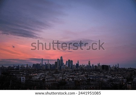 New York City skyline at sunset underneath an orange sky