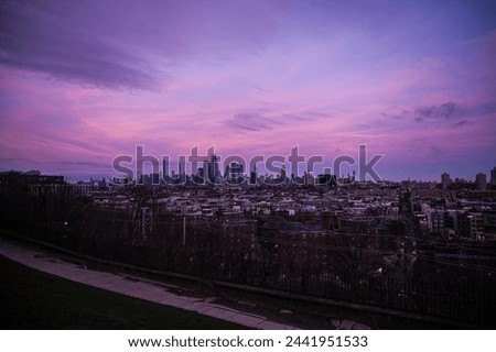 New York City skyline underneath a purple sky at sunset