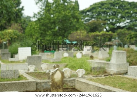 blurry, a grave or burial place and there are tombstones. blur or blurry background