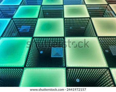 The photo is a square patterned floor with a green glow. The dance floor.