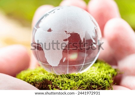 Glass Globe Cradled in Man's Palm, Earth Day and Environmental Conservation