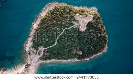 Aerial drone view of the Porto Palermo Castle in Albania. The castle is a significant monument located near the village of Himare in southern Albania. Royalty-Free Stock Photo #2441973055