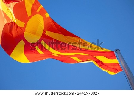 North macedonia flag waving in sunny blue sky
