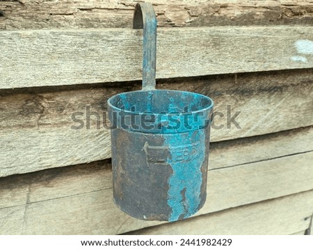 ancient iron canting or oil measure Royalty-Free Stock Photo #2441982429