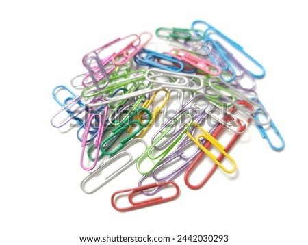 Metal paper clips, different colors on a white background