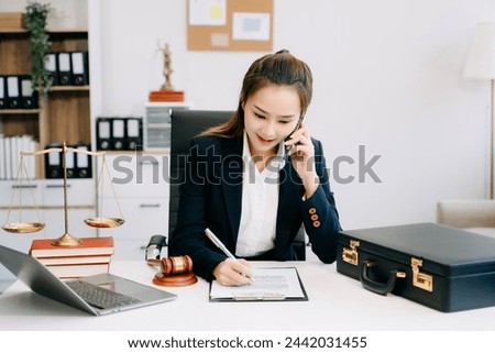 Beautiful asian woman lawyer working and gavel, tablet, laptop in front, Advice justice and law concept. in office