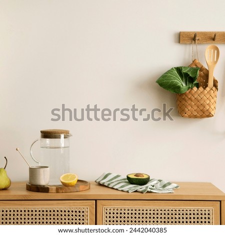 Warm and cozy interior design of kitchen space with rattan commode, ladder, hanger on the wall, herbs, vegetables, pitcher, avocado, pears, food and kitchen accessories. Home decor. Template. 