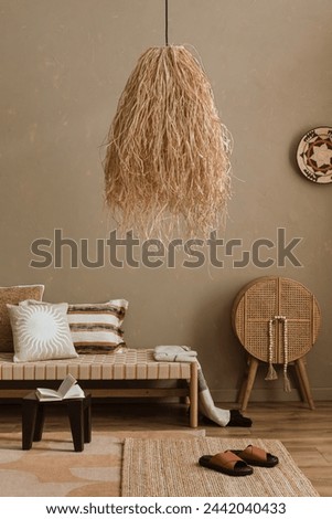 Minimalist composition of boho ethno living room with daybed, pillows, hanging decoration, beige accessories. Home decor. Template.	
 Royalty-Free Stock Photo #2442040433