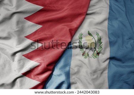 big waving national colorful flag of guatemala and national flag of bahrain. macro
