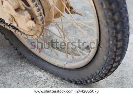 a motorbike tire is flat due to a leak