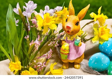 Happy Easter. Congratulatory easter background. Easter eggs Bunnies and flowers.