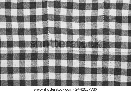 gray and white checkered background. material in a dark cell
