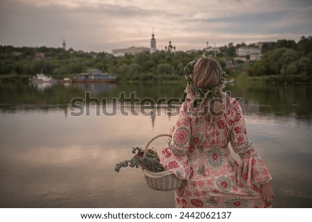 The girl by the river from the back Royalty-Free Stock Photo #2442062137