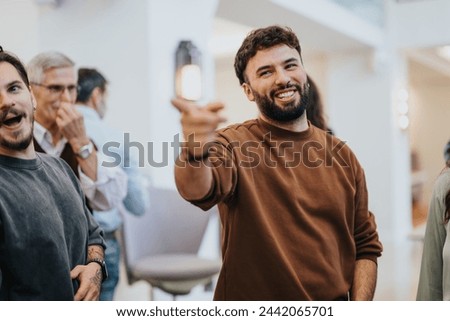 Joyful friends having fun and laughing together at social gathering. Royalty-Free Stock Photo #2442065701