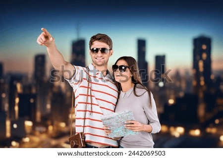 A happy couple on vacation enjoys view of city