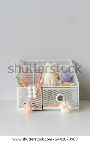 A charming workspace accented with a whimsical cat figurine, elegant stationery, and warm candlelight, exuding tranquility and style. Royalty-Free Stock Photo #2442070909