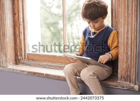 Home, tablet and serious child on internet, app or game on website for learning by windowsill. Technology, kid and boy in house for education, relax and watch cartoon online on digital electronics