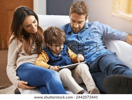 Family, parents and child with tablet for streaming, relax on couch with cartoon or e learning games at home for bonding. Love, care and trust with digital tech, play online or people watch a movie